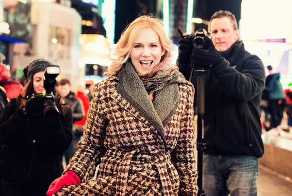 woman and papparazi at Times Square NY