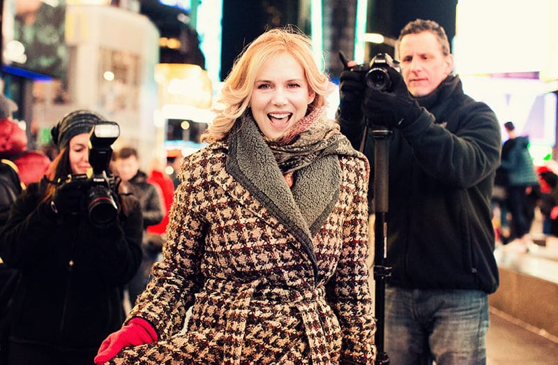 woman and papparazi at Times Square NY