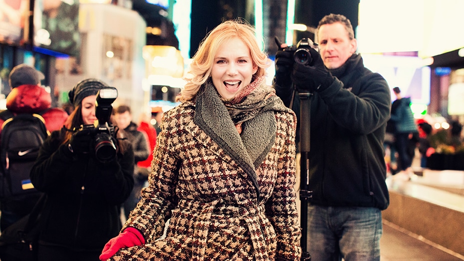 woman and papparazi at Times Square NY