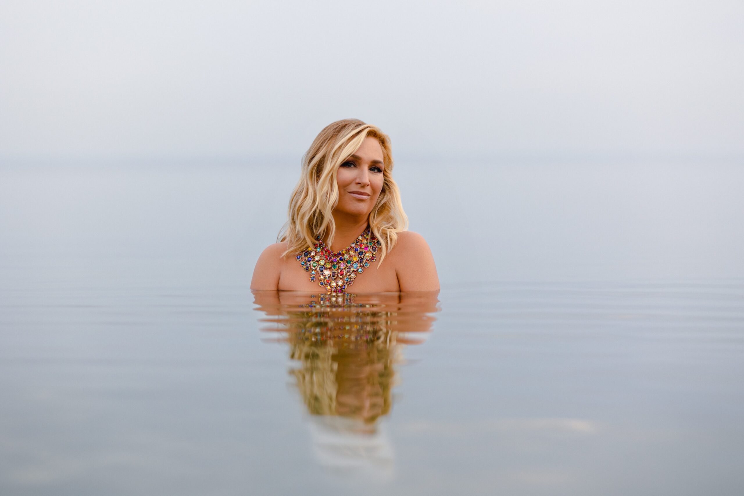 blond woman immersed in water, ocean stillness